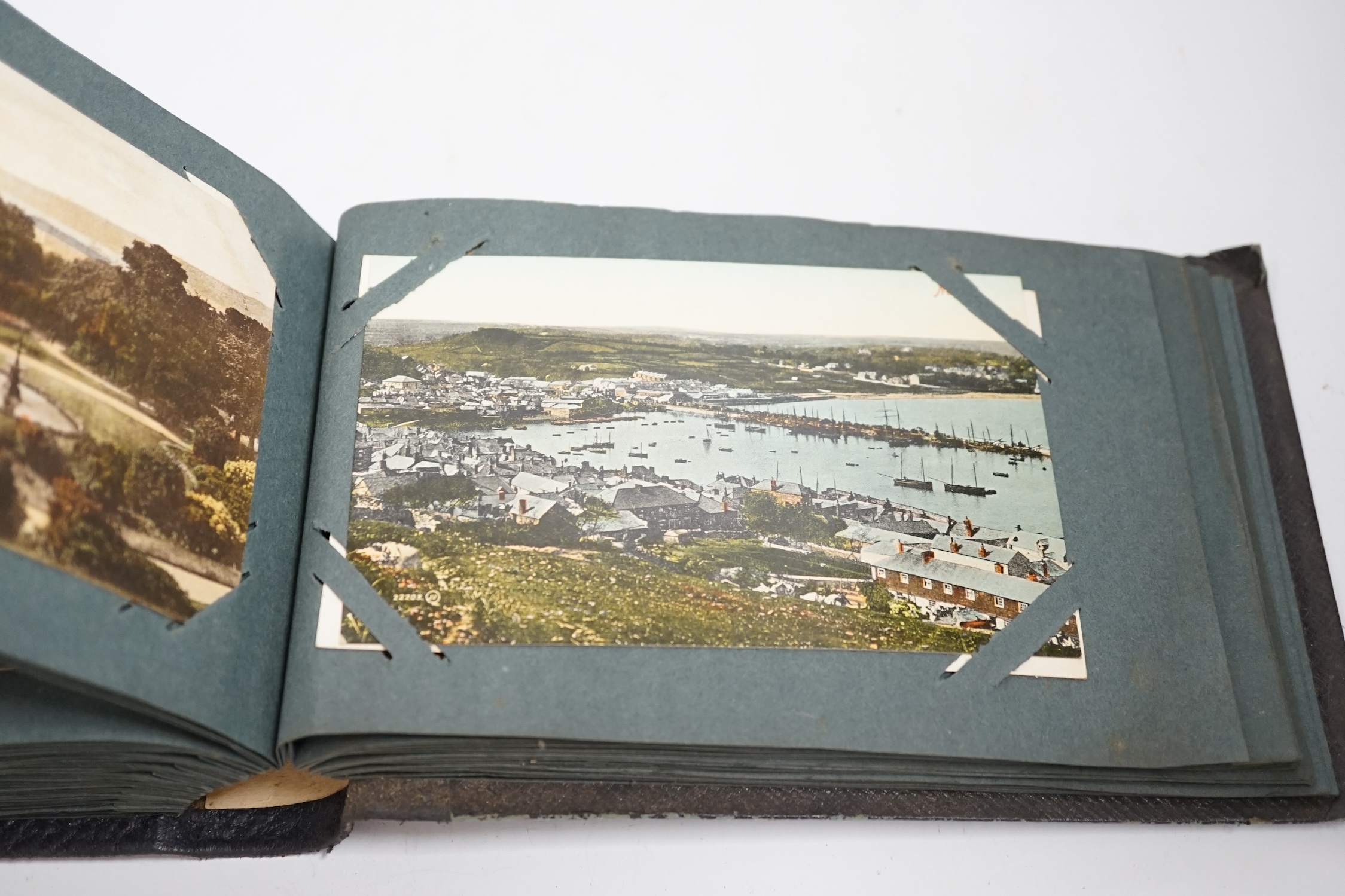 Three postcard albums, topographical examples including the Isle of Wight